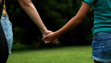 Woman-and-girl-walking-on-grass